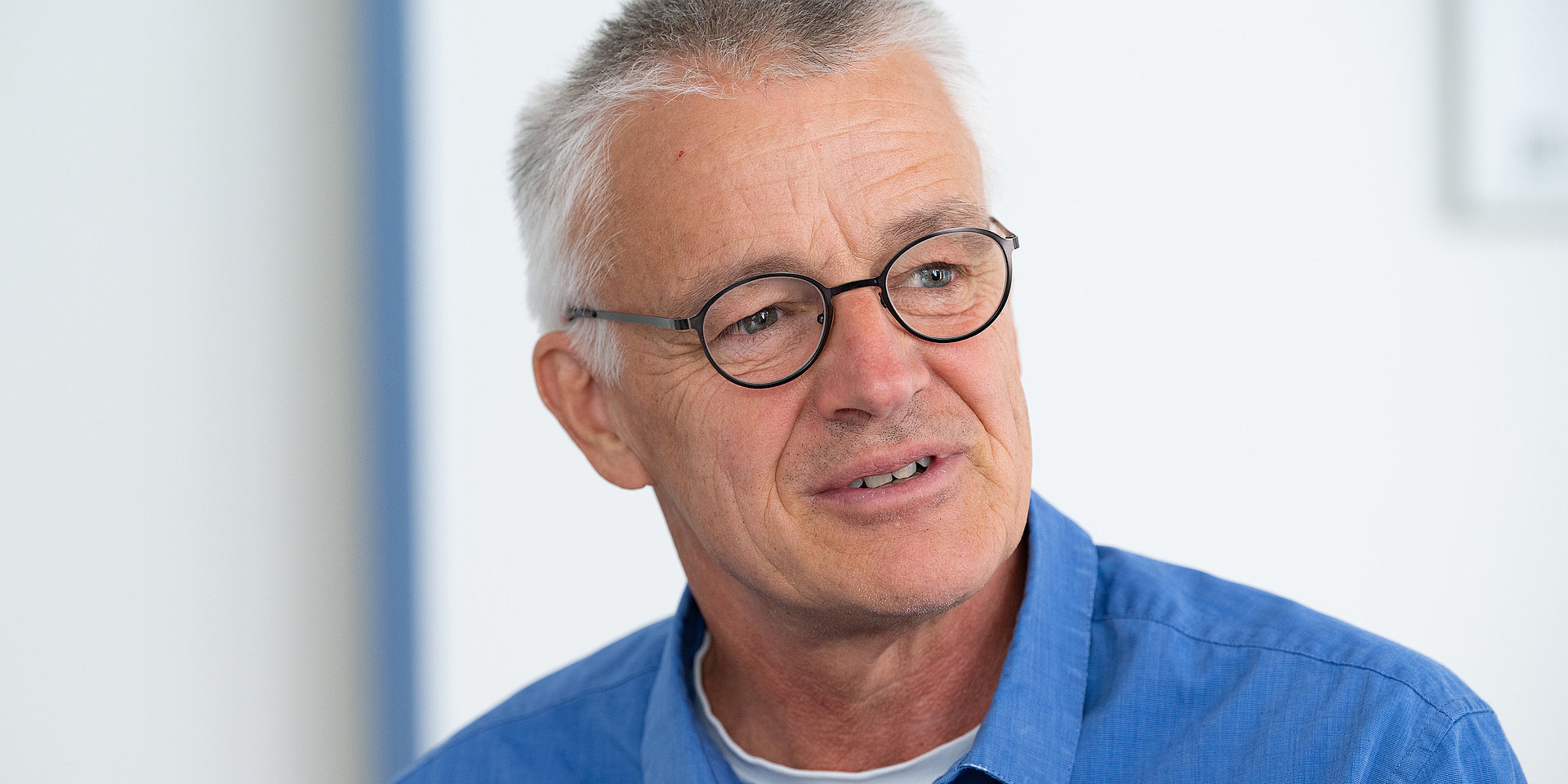 A portrait of Christoph Busch, wearing glasses against a light background.