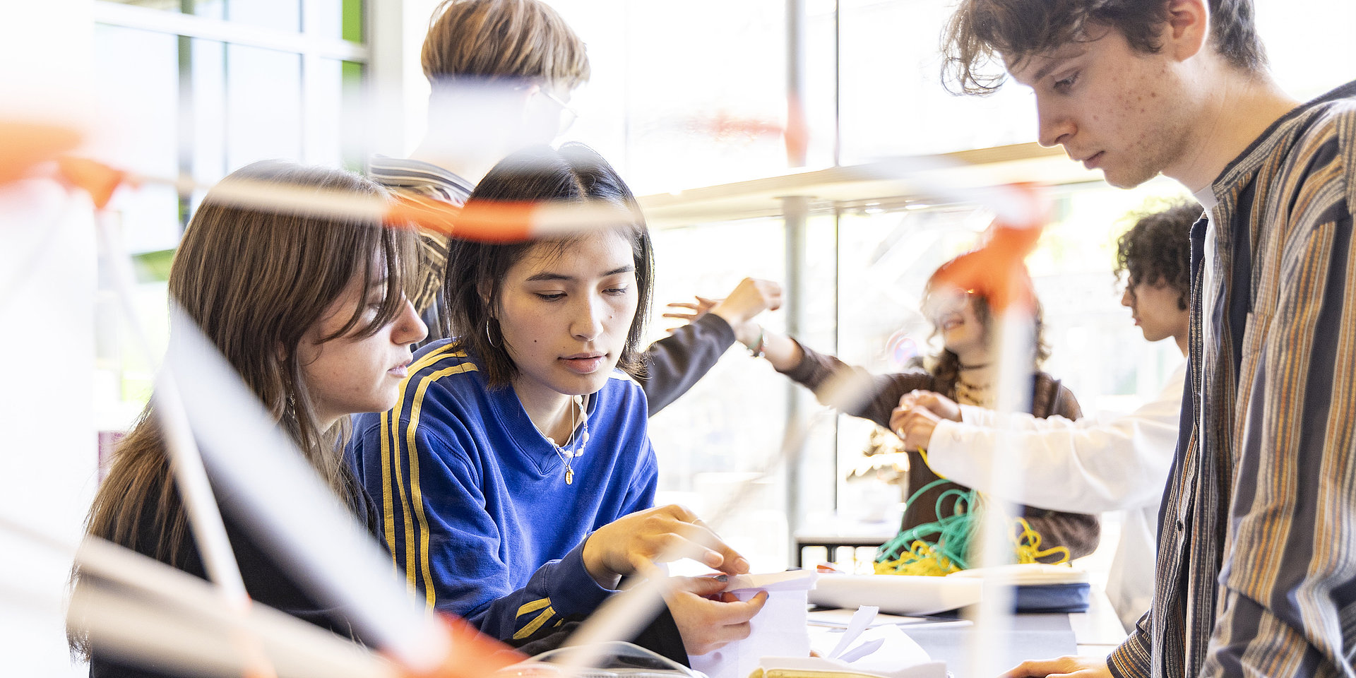 Three students are brainstorming together.