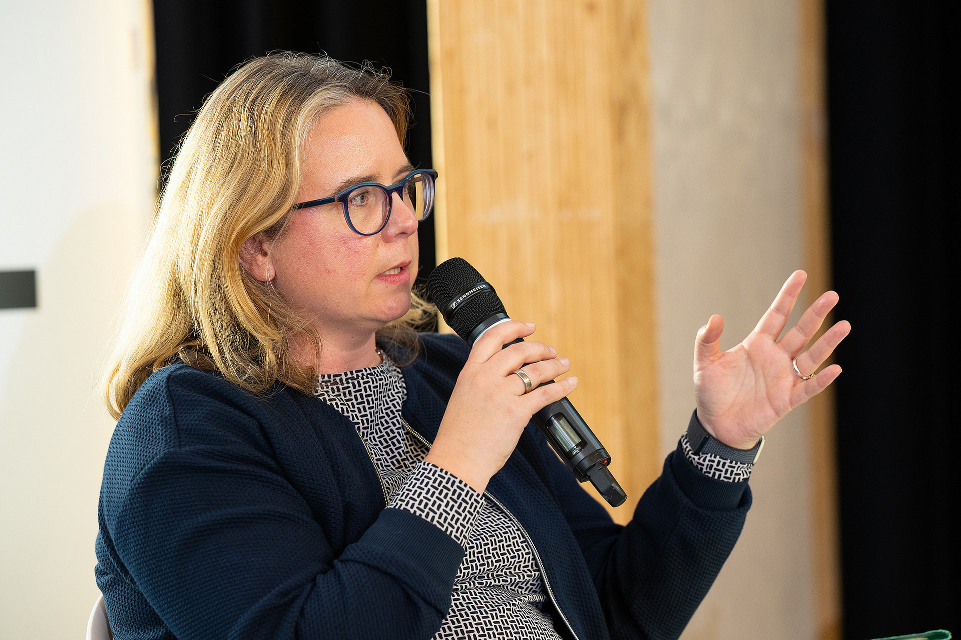 Charlotte Dany speaks and gestures with her hands.