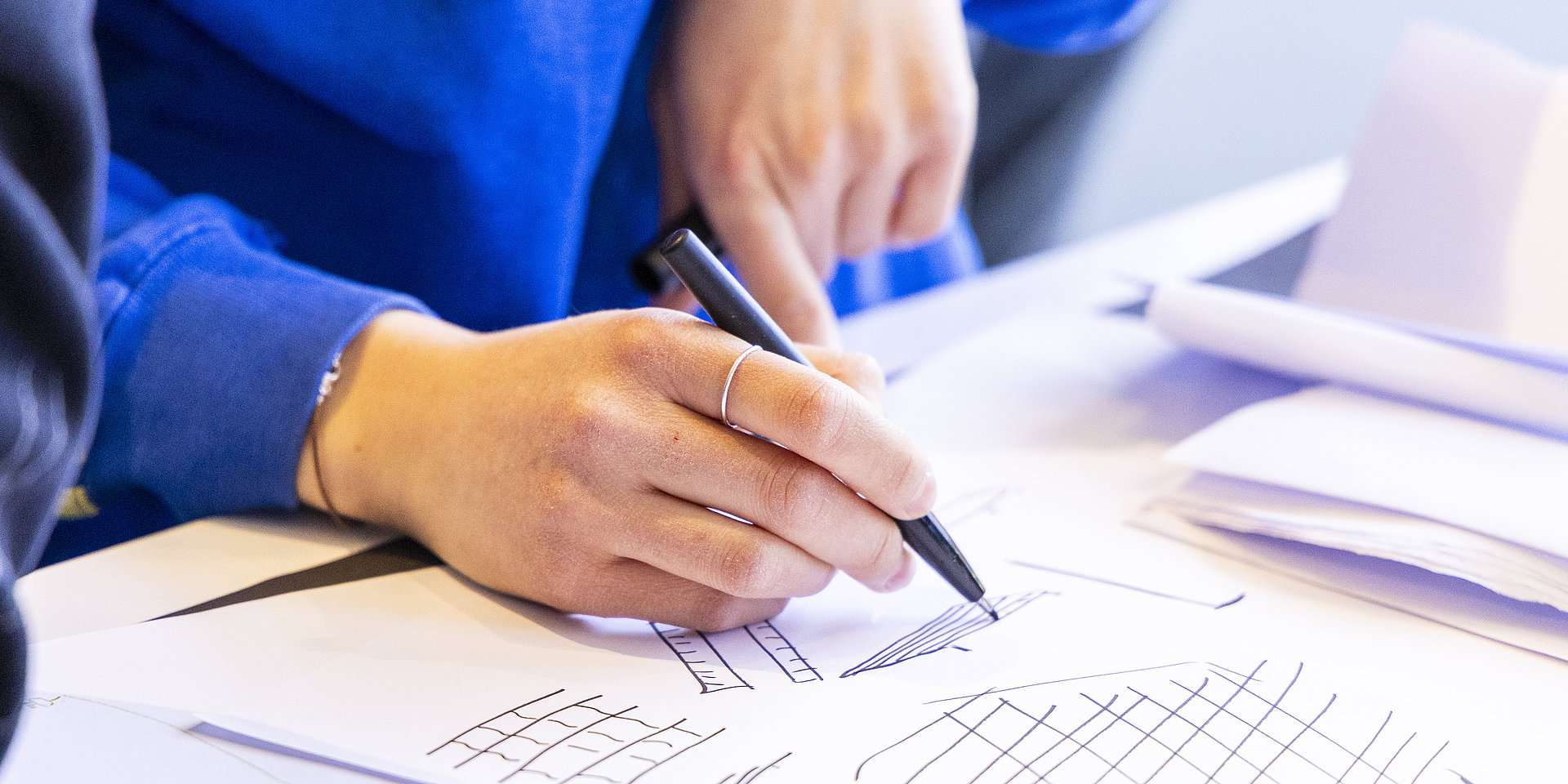A person writes notes on paper.