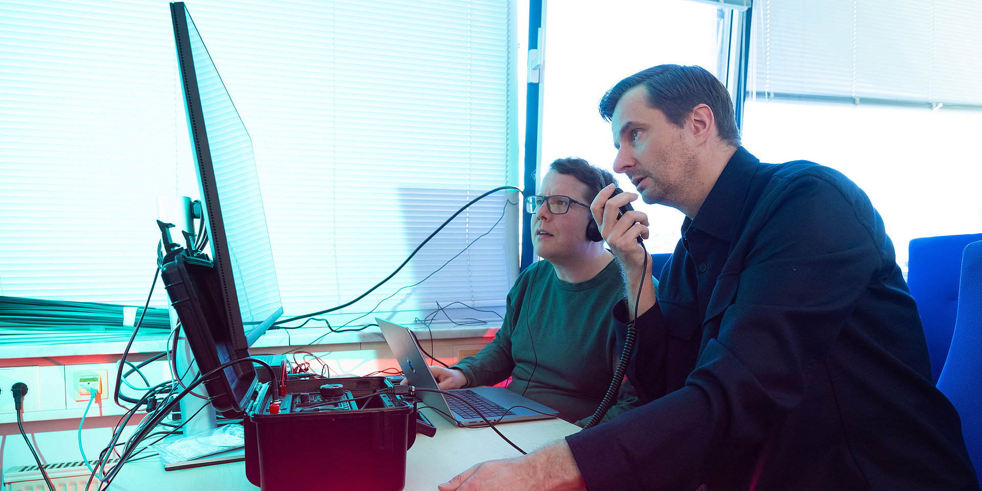 Prof. Valentin is speaking into a radio.
